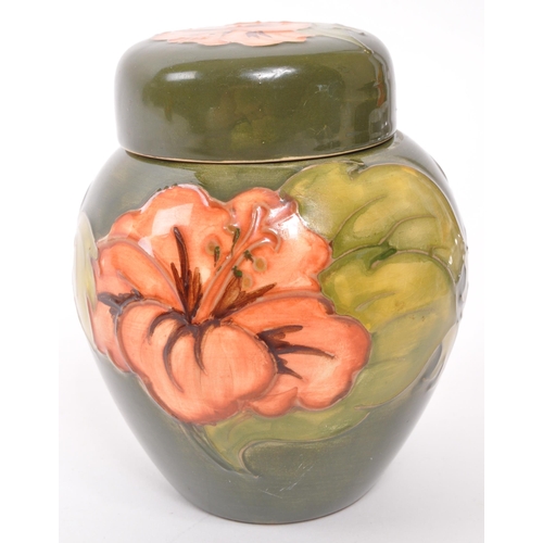 170 - Moorcroft Pottery - A late 20th century ginger jar in Hibiscus pattern on green ground, with maker m... 