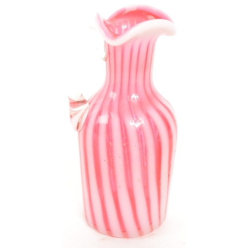 182 - A collection of early to late 20th century Nailsea type jug / pink scale bud vase. Together with an ... 