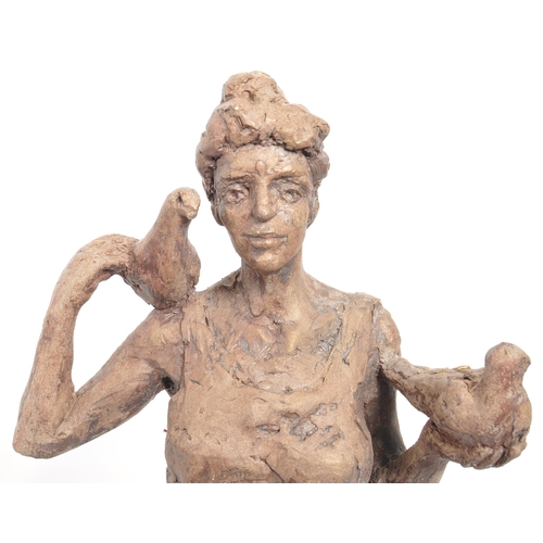 206 - A vintage 20th century sculpture of a woman with a dove on one shoulder, another in her hand. On a w... 