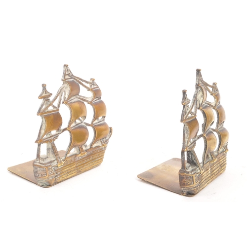 215 - A pair of early 20th Century 1920s brass ship bookends. The ships stood on rectangular brass bases e... 