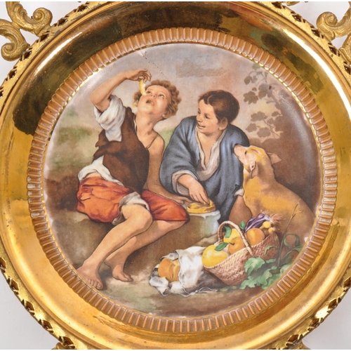 216 - A 19th Century Italian brass mounted ceramic plate. The plate depicting a scene of two children with... 