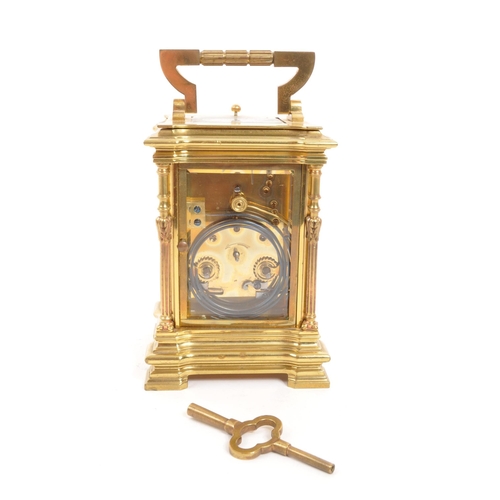 225 - A vintage mid century large brass carriage clock. Having a carry handle to top, a white enamelled fa... 