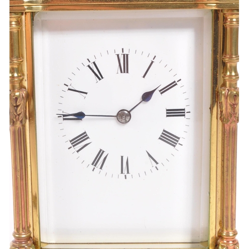 225 - A vintage mid century large brass carriage clock. Having a carry handle to top, a white enamelled fa... 