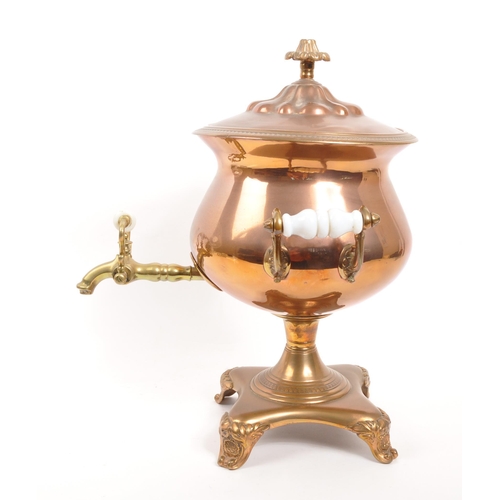 228 - A 19th century copper and brass pedestal samovar, with finial to lid and white porcelain handles.(40... 