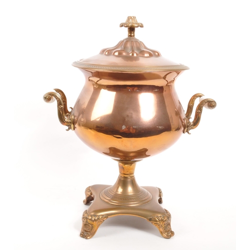 228 - A 19th century copper and brass pedestal samovar, with finial to lid and white porcelain handles.(40... 