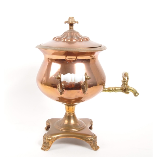 228 - A 19th century copper and brass pedestal samovar, with finial to lid and white porcelain handles.(40... 