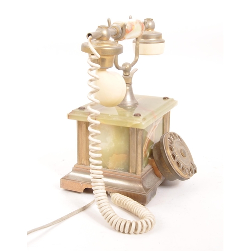 230 - A 20th Century vintage onyx telephone with metal rotary dial and cord to handset. The base of rectan... 