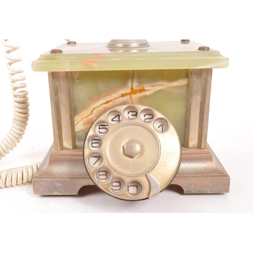 230 - A 20th Century vintage onyx telephone with metal rotary dial and cord to handset. The base of rectan... 