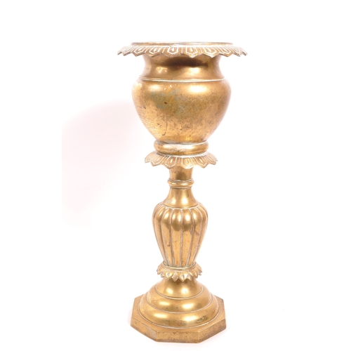 232 - A 20th century brass jardiniere plant stand. The stand having a stepped base, with gadrooned relief ... 