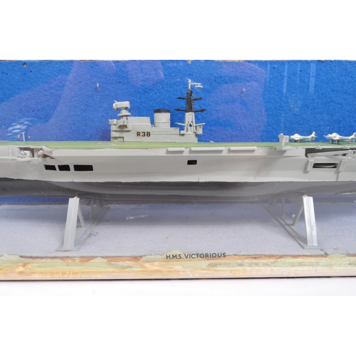 233 - H. M. S. Victorious - A vintage 20th century handmade model aircraft carrier vessel boat. In a glass... 