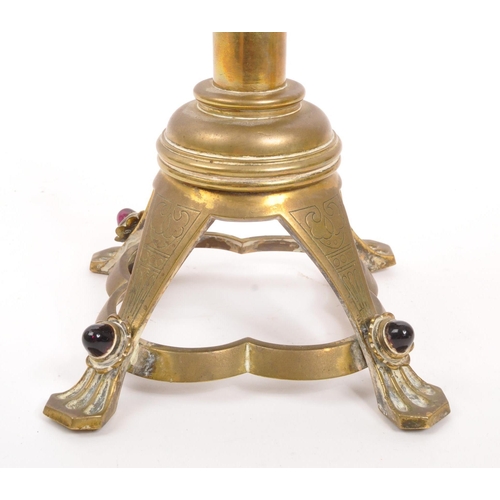 234 - A brass candelabra having glass cabochon detailing to arms and feet. The candelabra having circular ... 