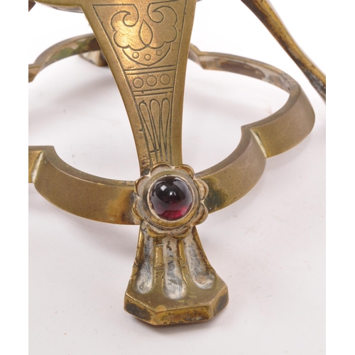 234 - A brass candelabra having glass cabochon detailing to arms and feet. The candelabra having circular ... 