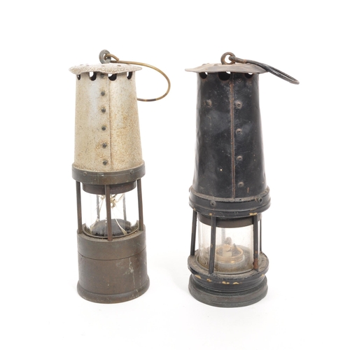 238 - J. H. Naylor Ltd - Two vintage 20th century miners' safety lamps / lights. Both with hanging hooks t... 