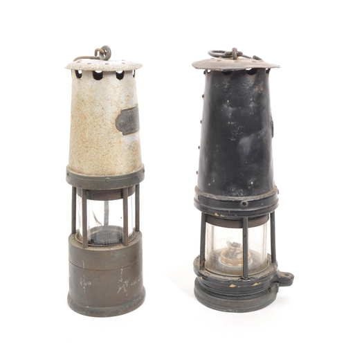 238 - J. H. Naylor Ltd - Two vintage 20th century miners' safety lamps / lights. Both with hanging hooks t... 