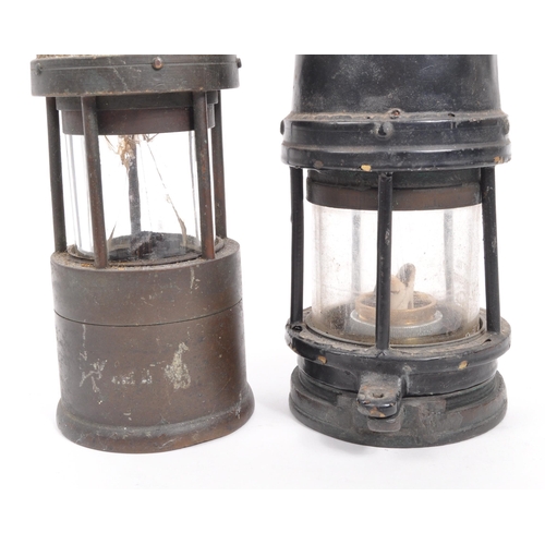 238 - J. H. Naylor Ltd - Two vintage 20th century miners' safety lamps / lights. Both with hanging hooks t... 