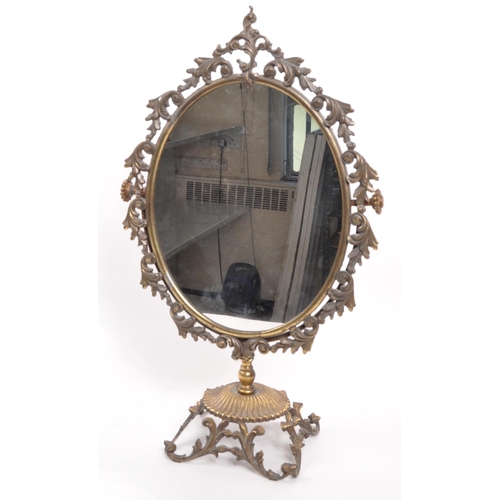 239 - An early 19th Century free standing dressing table mirror. The mirror of ovoid form raised upon scro... 