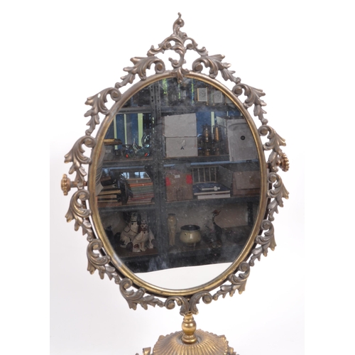 239 - An early 19th Century free standing dressing table mirror. The mirror of ovoid form raised upon scro... 