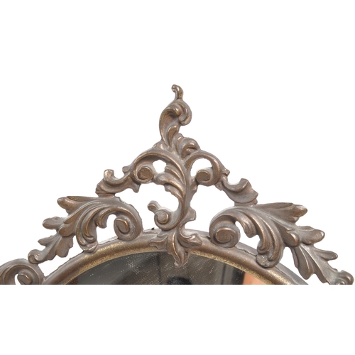 239 - An early 19th Century free standing dressing table mirror. The mirror of ovoid form raised upon scro... 