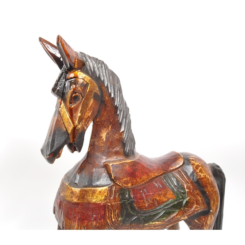 245 - A 20th century folk art painted carved wooden rocking horse. The rocking horse having small proporti... 