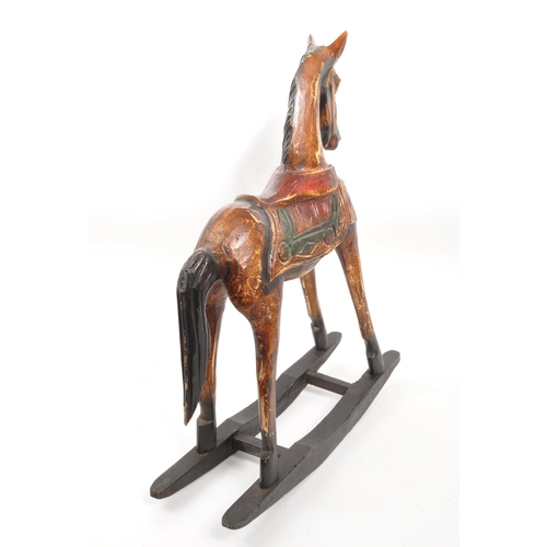 245 - A 20th century folk art painted carved wooden rocking horse. The rocking horse having small proporti... 