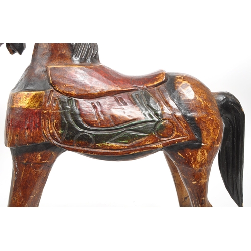 245 - A 20th century folk art painted carved wooden rocking horse. The rocking horse having small proporti... 