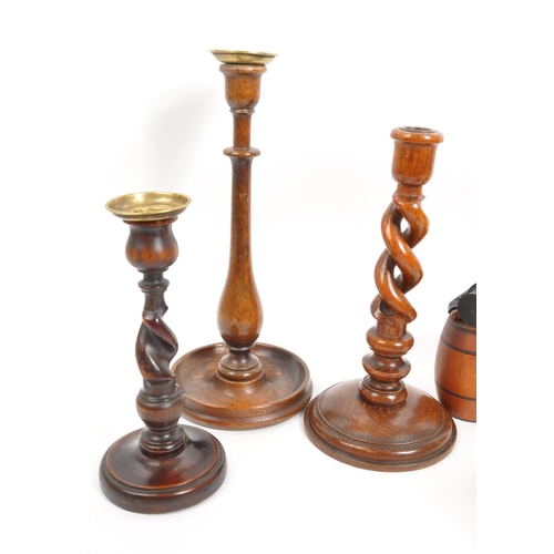 258 - A vintage collection of treen items. To include three pairs of wooden turned mahogany candlestick ho... 