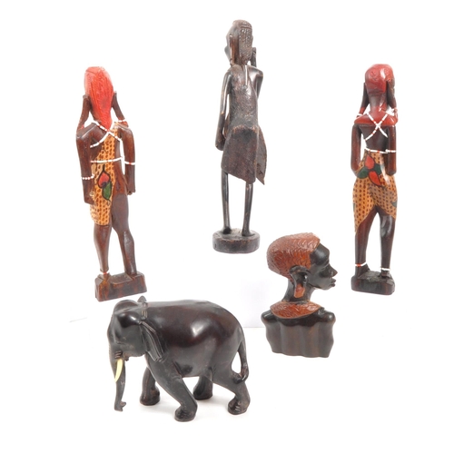 260 - A collection of four 20th Century wooden carved tribal figures. Two standing with bead decoration, a... 