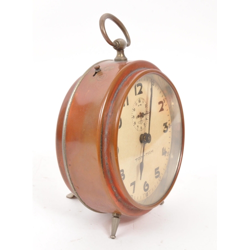 265 - A mid 20th century Kienzle Tam Tam alarm clock. The alarm clock of rounded and metal construction, w... 