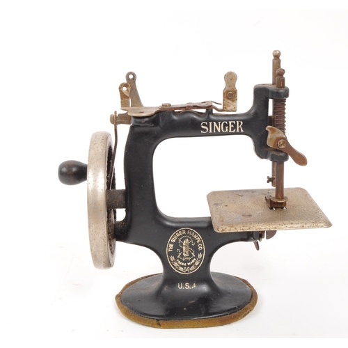 266 - Singer - An early 20th century Singer model 20 miniature sewing machine. The machine having a black ... 