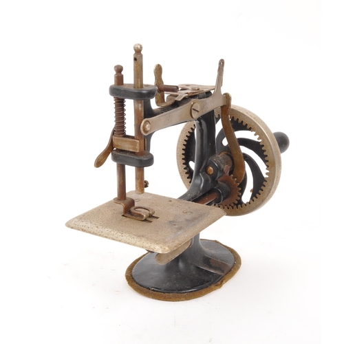 266 - Singer - An early 20th century Singer model 20 miniature sewing machine. The machine having a black ... 