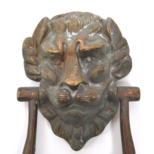 276 - A late 19th Century bronze ' lion mask ' door knocker with swing handle knocker. The lion with point... 