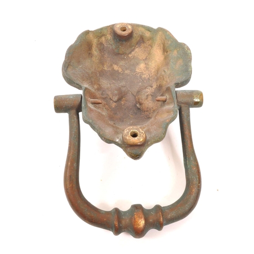 276 - A late 19th Century bronze ' lion mask ' door knocker with swing handle knocker. The lion with point... 