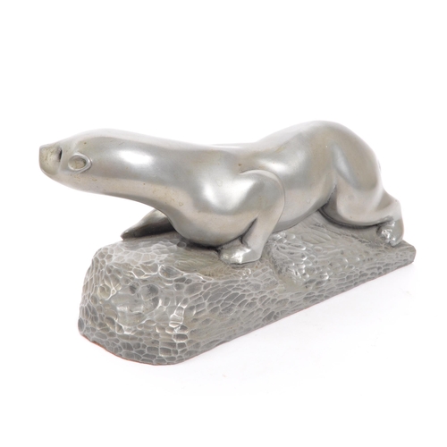 281 - The Fisher Collection -  A contemporary pewter style otter figurine by Richard Fisher on naturalisti... 