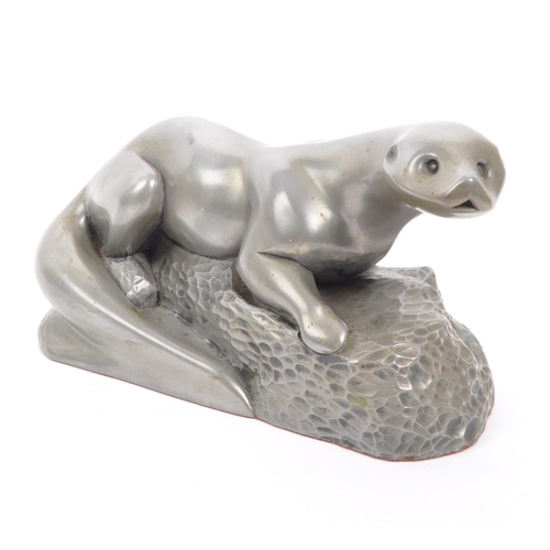 281 - The Fisher Collection -  A contemporary pewter style otter figurine by Richard Fisher on naturalisti... 