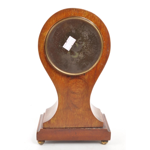 285 - An Edwardian walnut inlaid balloon shaped mantel clock with shell design inlay. Raised on rectangula... 