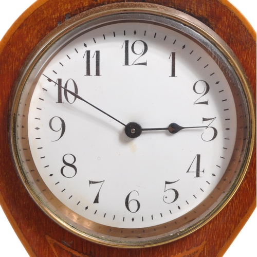 285 - An Edwardian walnut inlaid balloon shaped mantel clock with shell design inlay. Raised on rectangula... 