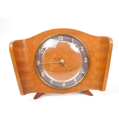 294 - Collection of four mid-century mantel clocks. Teak examples, one being bentwood. They are Smiths and... 