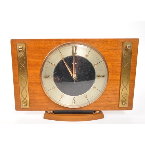 294 - Collection of four mid-century mantel clocks. Teak examples, one being bentwood. They are Smiths and... 