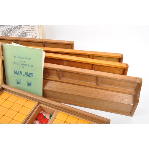 295 - Two 20th Century mahjong game sets each held within wooden boxes. Together with seven vintage wooden... 