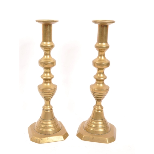 297 - A collection of 19th and 20th Century candlesticks comprising of two matching Victoran brass ' beehi... 