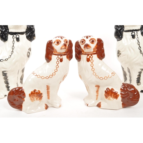 30 - Two pairs of 20th Century ceramic hand painted Staffordshire spaniel dogs. The larger examples black... 