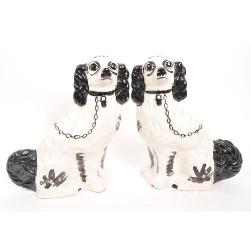 30 - Two pairs of 20th Century ceramic hand painted Staffordshire spaniel dogs. The larger examples black... 