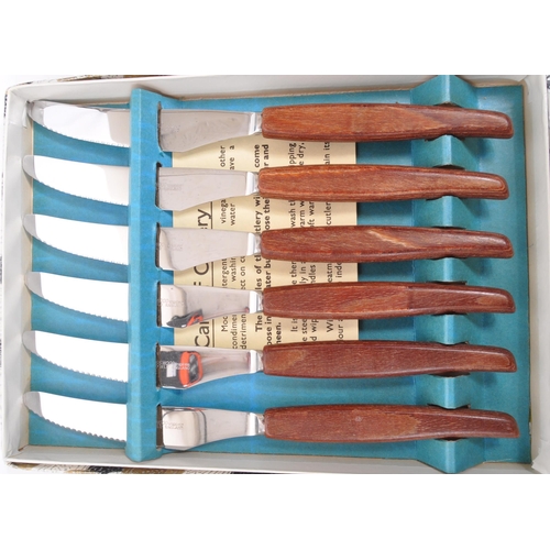 306 - Glosswood - A collection of boxed mid 20th century Glosswood stainless steel cutlery. The collection... 