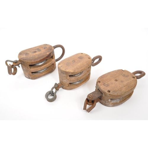 308 - A group of vintage 20th century maritime ships dock rope pulleys. Wooden construction with metal rin... 