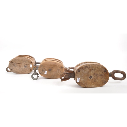 308 - A group of vintage 20th century maritime ships dock rope pulleys. Wooden construction with metal rin... 