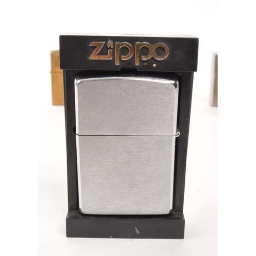 309 - A collection of five 20th century Zippo lighters. The lighters all stamped with Zippo branding to ba... 