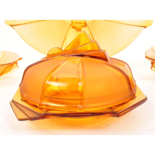 31 - A collection of 20th Century Art Deco amber glass items comprising of lidded pot / bowl, tray and ma... 