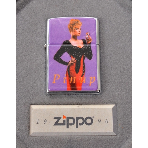 311 - Zippo - Two 20th century Zippo lighters in tins. The collection to include a Zippo Pinup Girl lighte... 