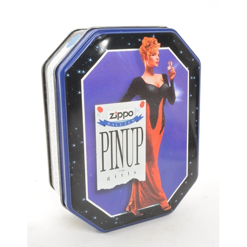 311 - Zippo - Two 20th century Zippo lighters in tins. The collection to include a Zippo Pinup Girl lighte... 