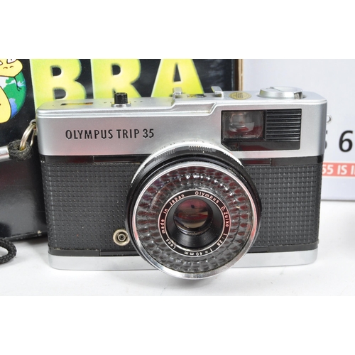 319 - Canon EOS 1000 - Olympus Trip 35 - Two vintage 20th century cameras. Together with a Cobra optics mo... 